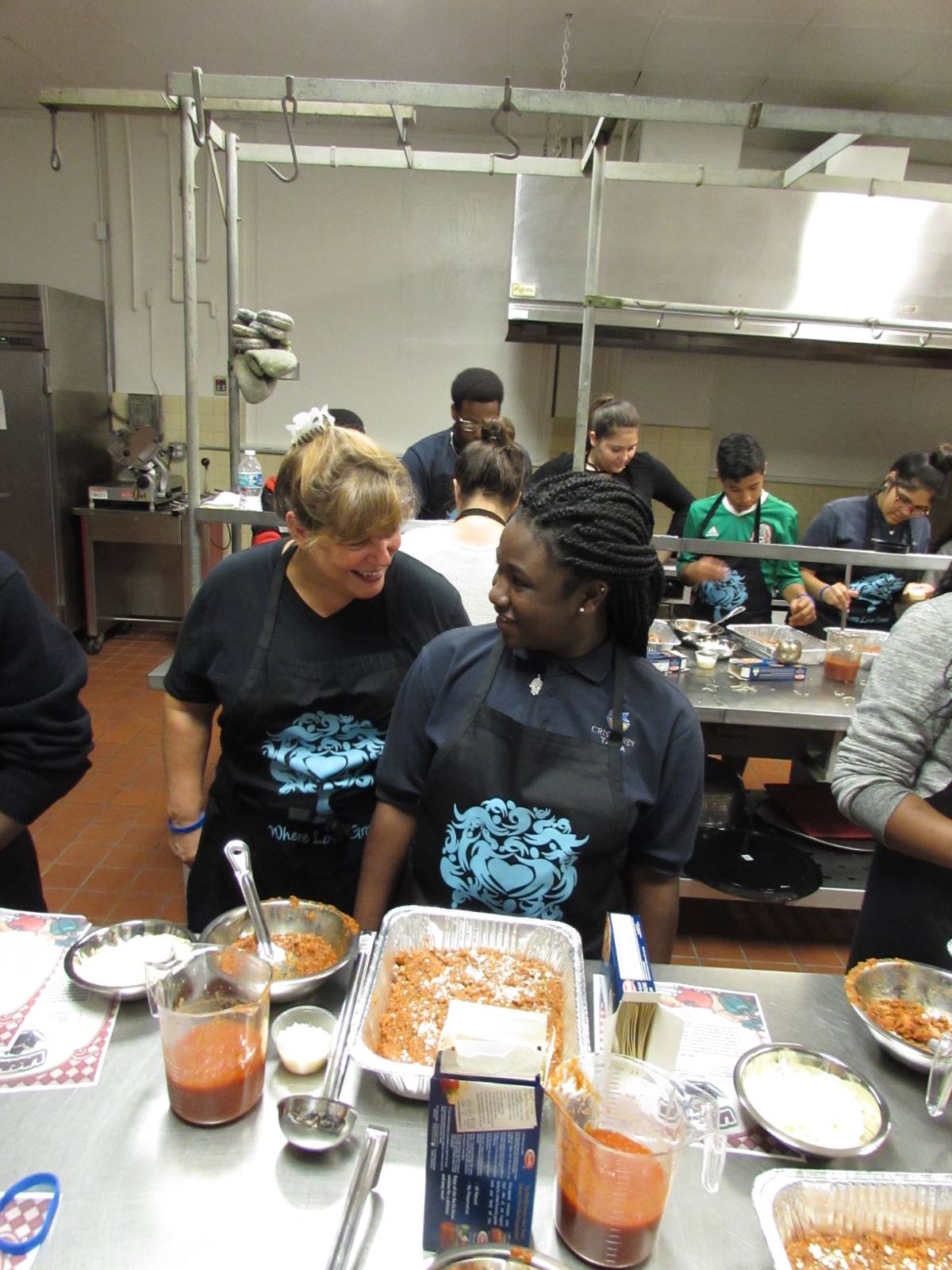 A group of people in a kitchen preparing food.